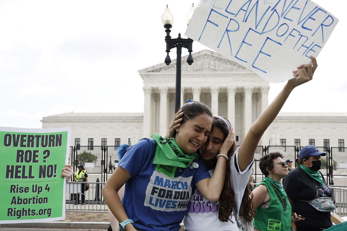 <i>Anna Moneymaker/Getty Images</i><br/>Abortion rights activists Carrie McDonald  (L) and Soraya Bata react to the Dobbs v Jackson Women's Health Organization ruling which overturns the landmark abortion Roe v. Wade case in front of the U.S. Supreme Court on June 24 in Washington