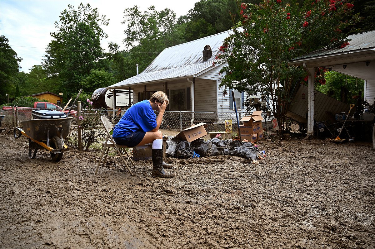 <i>Timothy D. Easley/AP</i><br/>Teresa Reynolds sits exhausted as members of her community clean the debris from their flood ravaged homes at Ogden Hollar in Hindman