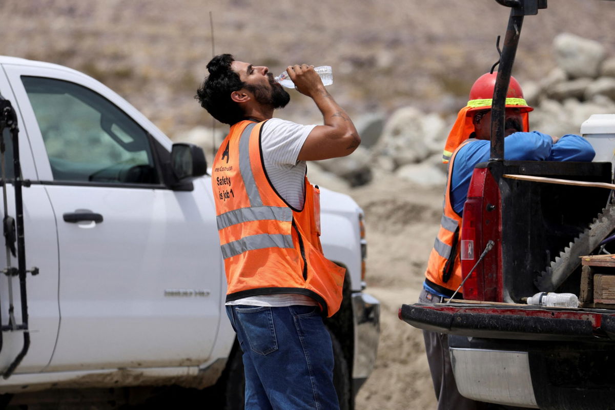 <i>David Swanson/Reuters</i><br/>A construction worker drinks water in temperatures that have reached well above triple digits in Palm Springs