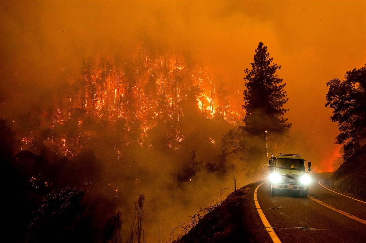 <i>Noah Berger/AP</i><br/>A fire truck drives along California Highway 96 as the McKinney Fire burns in Klamath National Forest