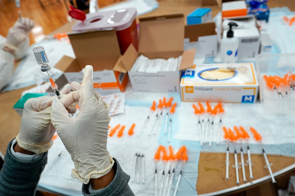 <i>Mary Altaffer/AP/FILE</i><br/>A nurse preps a syringe at a pop-up Covid-19 vaccination site in the New York borough of Staten Island in April 2021. Covid-19 cases are increasing across the United States once again.