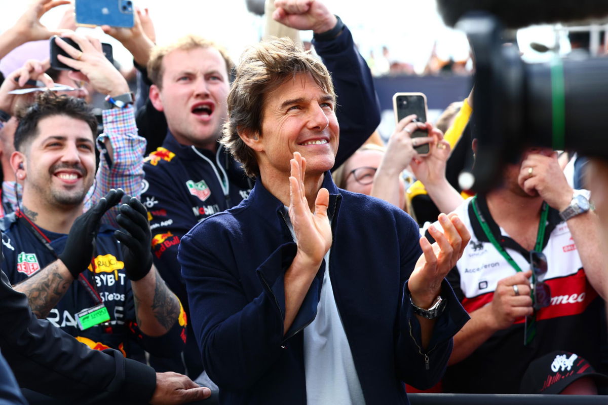 <i>Mark Thompson/Getty Images</i><br/>Tom Cruise applauds at the Podium celebrations during the F1 Grand Prix of Great Britain at Silverstone on Sunday in Northampton