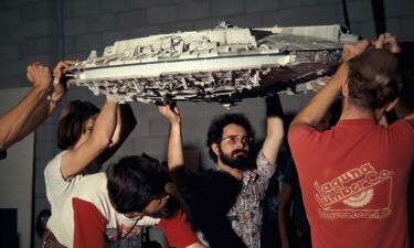 Special effects artists hoist a Millennium Falcon model while making "Star Wars" in "Light & Magic."