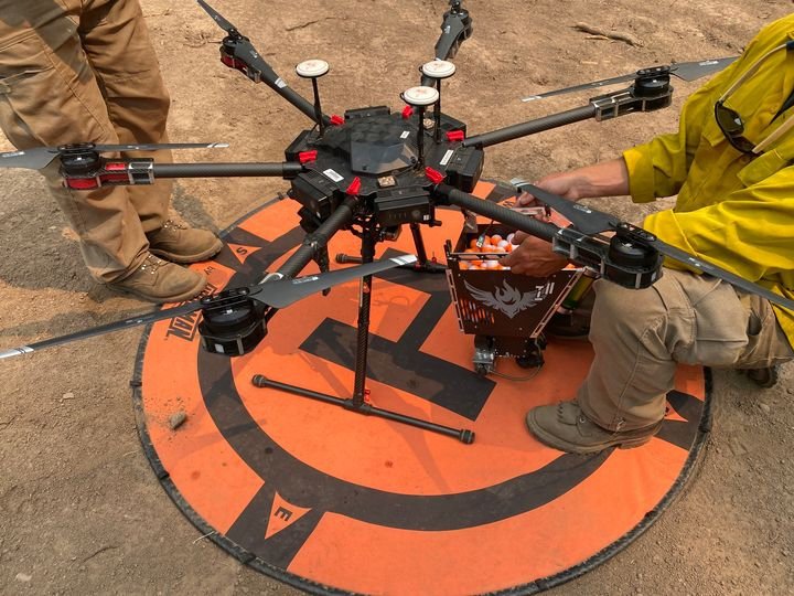 The UAS (Unmanned Aircraft System) shown here is an M600 Type 3 Hexacopter, equipped with infrared and video cameras; this small, portable aircraft can find hot spots in the thick smoke, perform scouting missions in the dark, and conduct firing operations by dropping 
