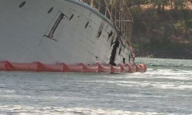 Work is underway Wednesday morning to remove a derelict boat from the Sacramento River.