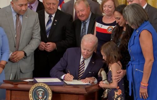 President Joe Biden signs the PACT Act into law at the White House on Wednesday - legislation aimed at expanding healthcare benefits for veterans and addressing exposure to toxic chemicals.