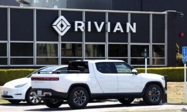 A Rivian electric pickup truck sits in a parking lot at a Rivian service center on May 9