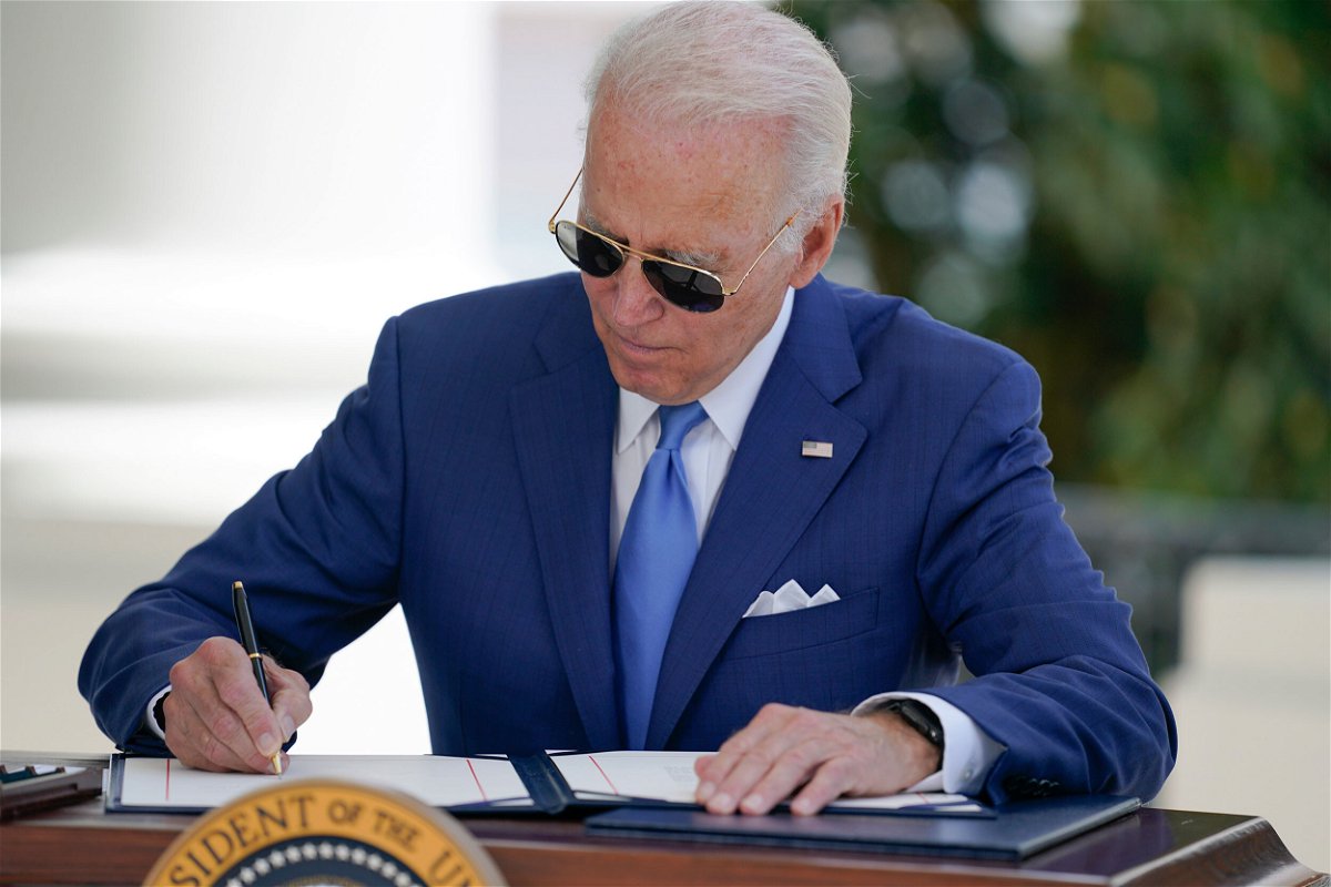 <i>Evan Vucci/AP</i><br/>President Joe Biden signs two bills aimed at combating fraud in the Covid-19 small business relief programs on August 5 at the White House in Washington.