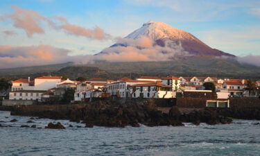 The highest mountain of Portugal isn't on the European mainland. It's the Azores volcano Montanha do Pico on the island of Pico. The village Madalena is seen below at sunset.