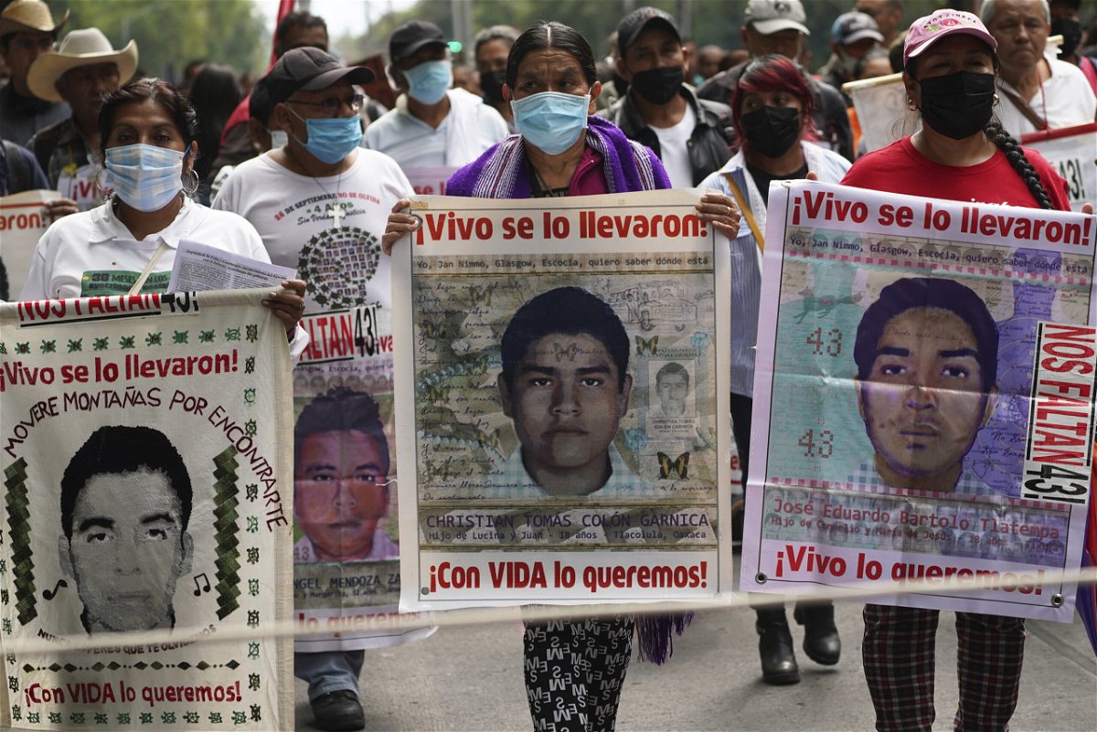 <i>Marco Ugarte/AP</i><br/>Family members and friends march seeking justice for the missing 43 Ayotzinapa students in Mexico City on August 26.