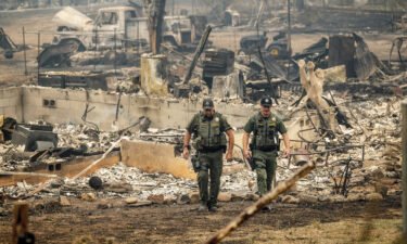 Officials have identified four people killed in the McKinney Fire in California as residents of the same community. Sheriff's deputies leave a home where a McKinney Fire victim was found on August 1