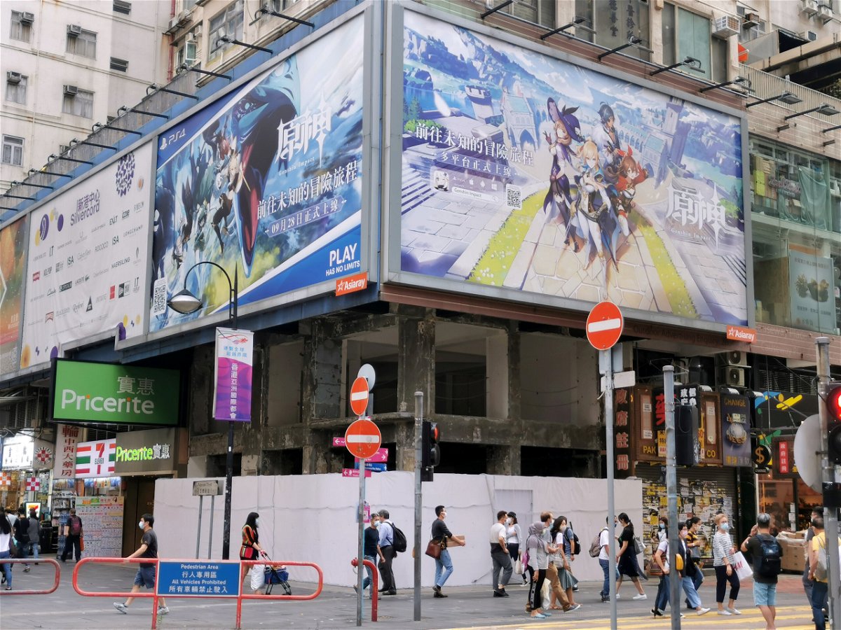 <i>Pei Li/Reuters</i><br/>People walk below a billboard ad of fantasy game 