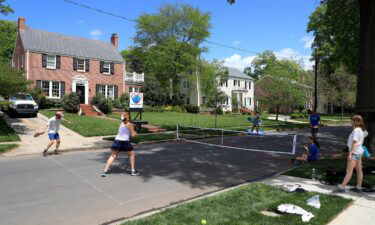 People play pickleball on an empty street in Charlotte during the early days of the coronavirus pandemic.