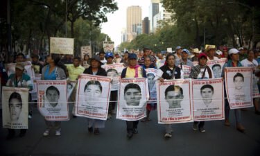 People march during a protest demanding justice in the case of the students of Ayotzinapa