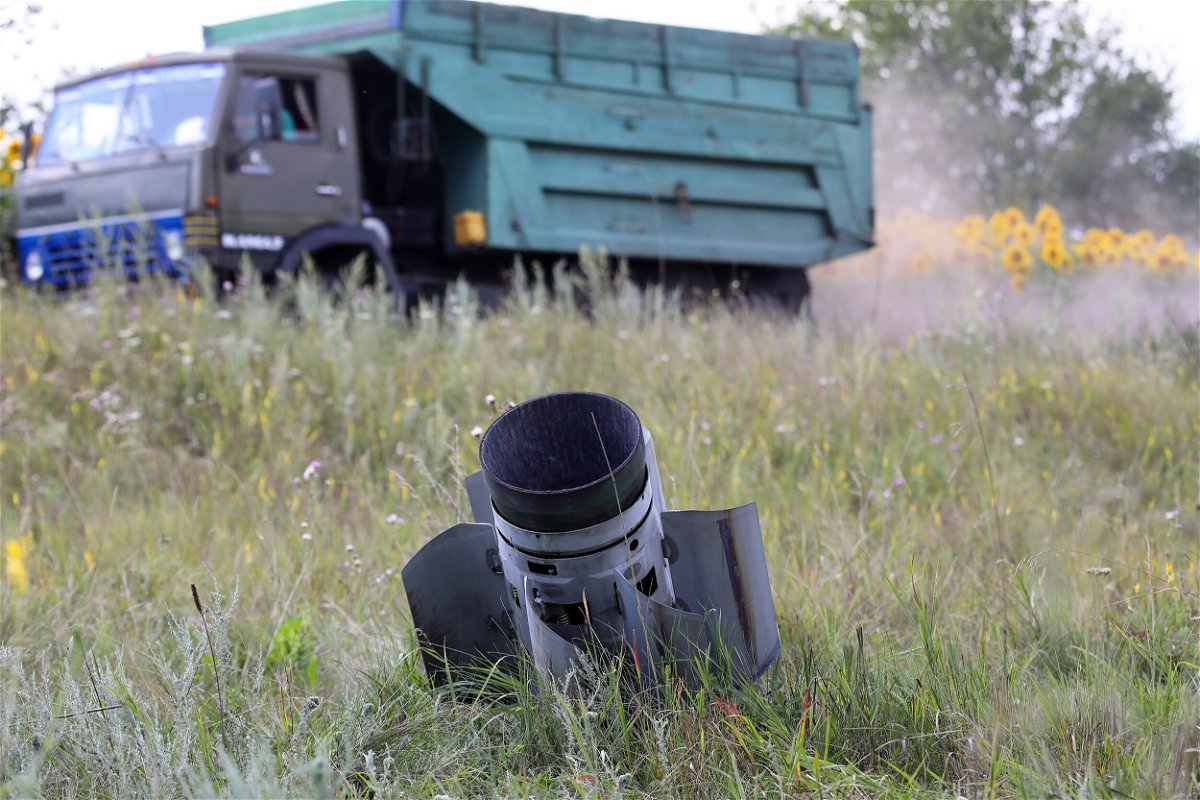 <i>Vyacheslav Madiyevskyy/Ukrinform/Future Publishing/Getty Images</i><br/>A Russian missile is stuck in the ground as the harvest season is underway in the northern part of the region despite Russian shelling