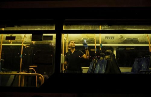 An Israeli police officer checks a bus following a shooting incident in Jerusalem
