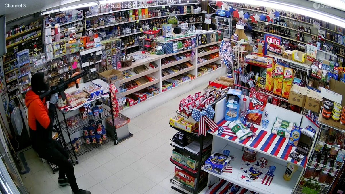 <i>Uncredited</i><br/>Surveillance video captured the moment an attempted convenience store robbery in Los Angeles was foiled on July 31. This photo shows the suspect entering the store and pointing a rifle at the 80-year-old store owner behind the counter before the owner pulled out a firearm and shot him.