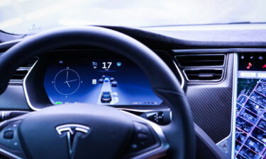 An instrument panel illustrates the road ahead using Autopilot technology inside a Model S P90D vehicle in New York in September 2016. Tesla 'full self-driving' debate escalates with legal threats and banned videos.