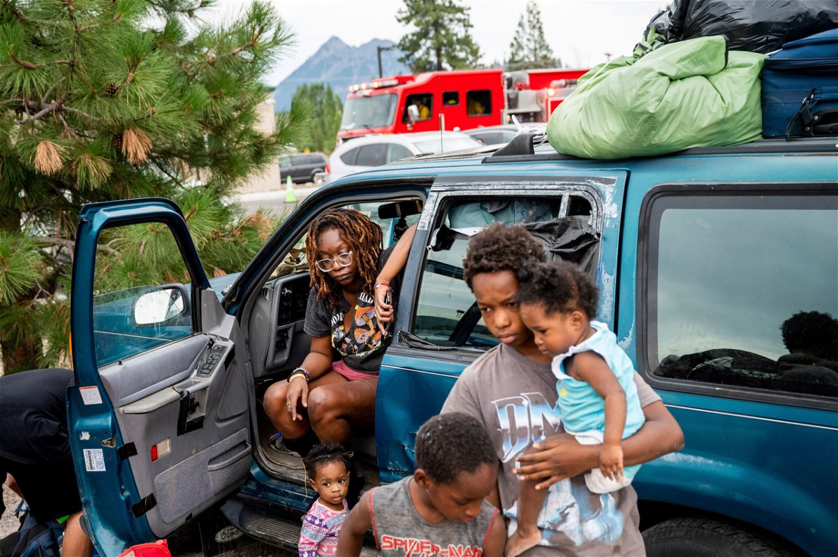 <i>Noah Berger/AP</i><br/>Paisley Bamberg and her family spend time outside a shelter for McKinney Fire evacuees in Weed
