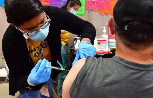 Registered Nurse Mariam Salaam administers the Pfizer booster shot at a Covid vaccination and testing site decorated for Cinco de Mayo at Ted Watkins Park in Los Angeles on May 5.