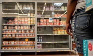 A customer stands waiting for assistance to receive baby formula in a Walmart Supercenter on July 8