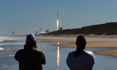 People watch from Canaveral National Seashore as a SpaceX Falcon 9 rocket launches from pad 39A at the Kennedy Space Center in Cape Canaveral