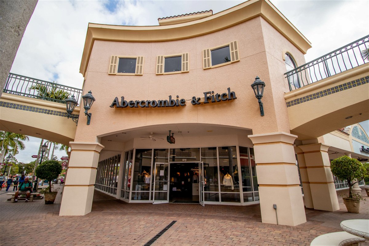 <i>Adobe Stock</i><br/>Shoppers walk past the facade of Abercrombie & Fitch Clothing Store in Miromar Outlets as the retailer that focuses on casual wear.