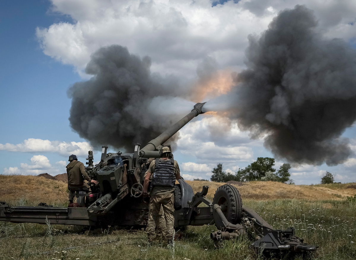 <i>Gleb Garanich/Reuters</i><br/>Ukrainian service members fire a shell from a towed howitzer FH-70 at a front line