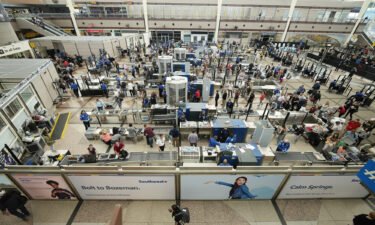 Travelers line up at Denver International Airport on the Thursday before Memorial Day this year. The record revenue many airlines reported in April