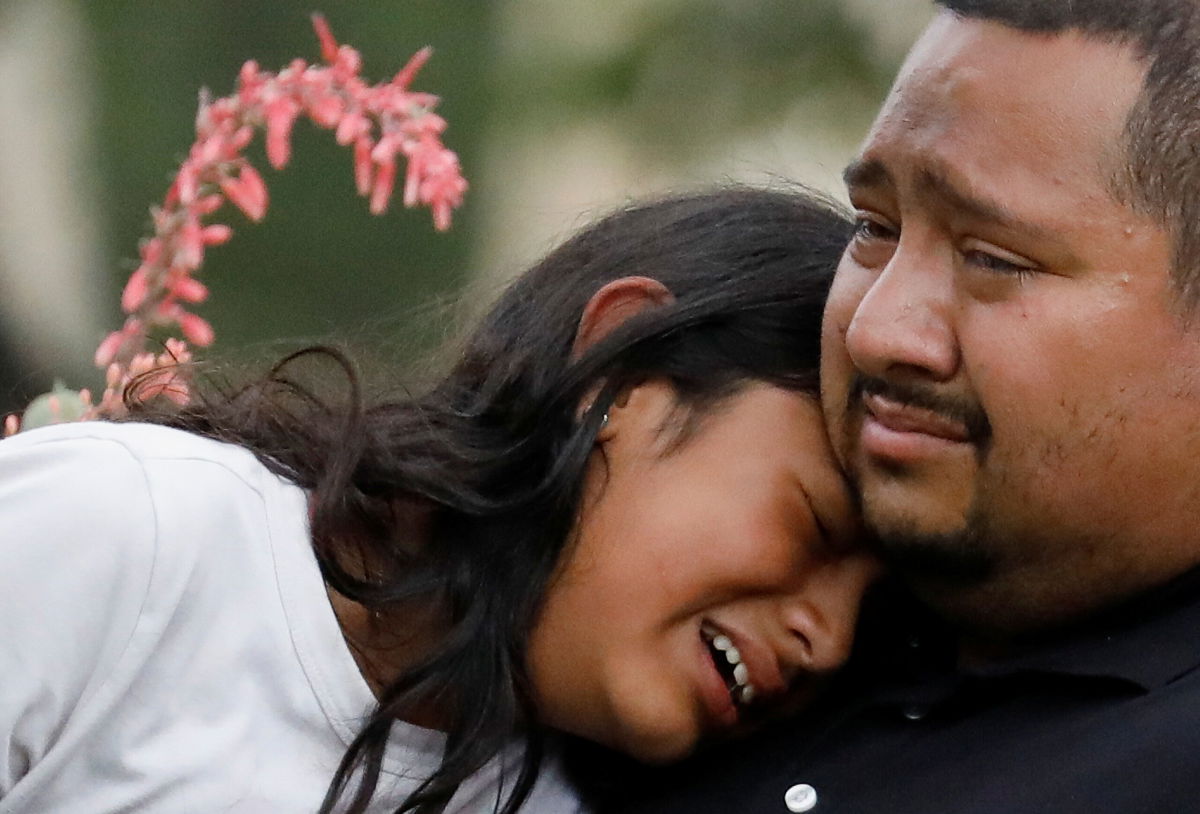 <i>Marco Bello/Reuters</i><br/>People cry May 24 outside a civic center where students were taken from Robb Elementary.