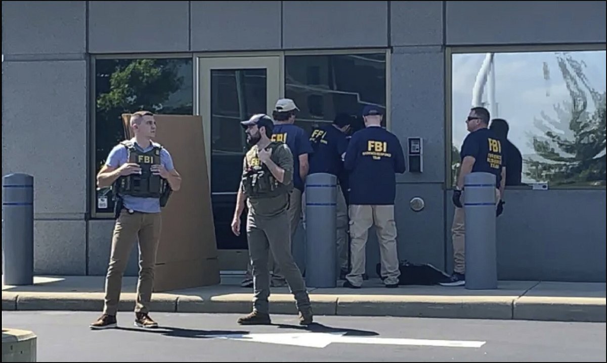 <i>AP</i><br/>FBI officials gather outside the FBI building in Cincinnati on August 11 after an armed man tried to breach a security screening area leading to an hours-long standoff with law enforcement.