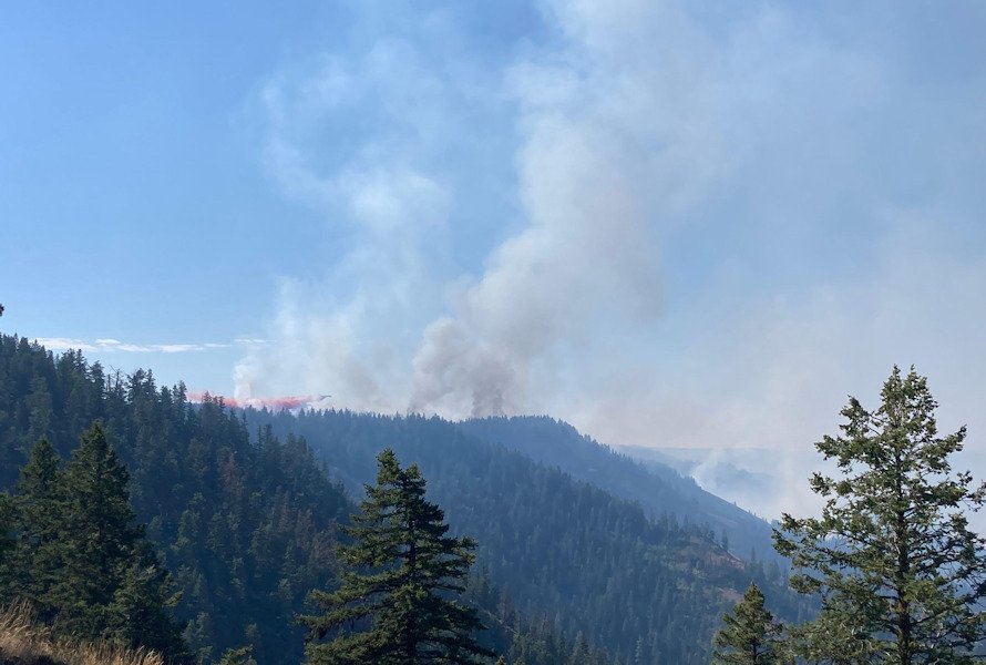 Plane drops retardant on the Double Creek Fire on Friday