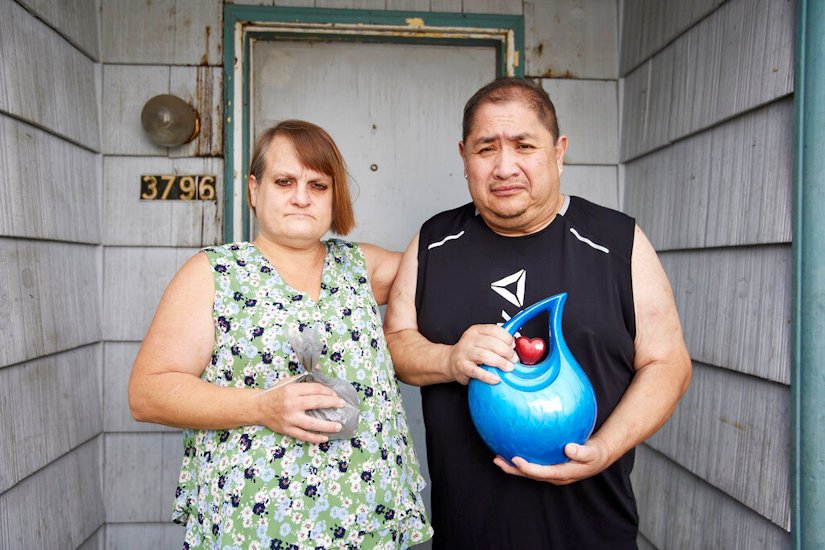 Misty Castillo, left, and her husband Arcadio stand in front of their home, holding the urn containing the ashes of their son Arcadio Castillo III, who was shot in 2021 by Salem police, in Salem, Ore., Thursday, Aug. 18, 2022. Misty called 911 and asked for the police, saying her son was mentally ill, was assaulting her and her husband and had a knife. Less than five minutes later, a police officer burst into the house and shot him