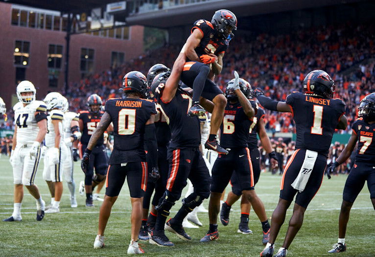 Oregon State wide receiver Anthony Gould is lifted by offensive lineman Jake Levengood after scoring a touchdown against Montana State during the first half of Saturday night's contest in Portland