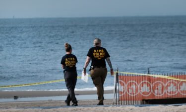 Police work along a stretch of beach at Coney Island