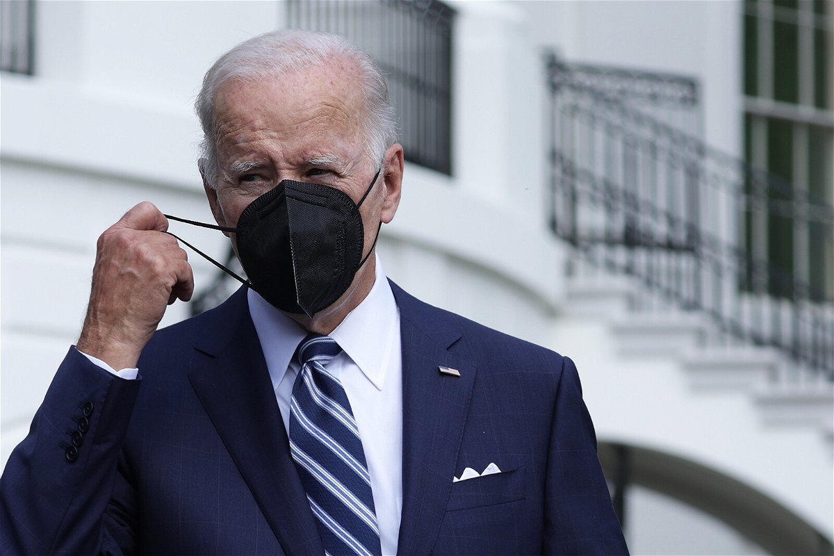 <i>Alex Wong/Getty Images</i><br/>U.S. President Joe Biden takes off his mask as he walks toward members of the press on August 26 in Washington