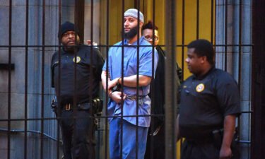 Officials escort "Serial" podcast subject Adnan Syed from the courthouse on Feb. 3