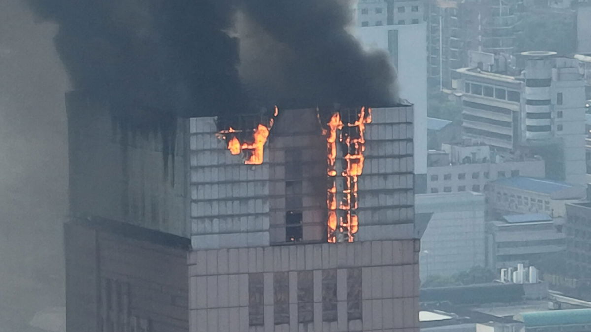 <i>VCG via Getty Images</i><br/>Flames and smoke rise from the 218-meter-tall office building in Changsha on September 16.