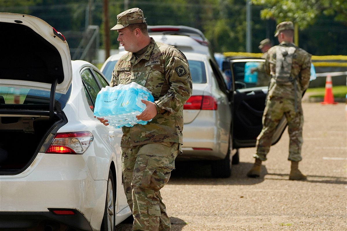 <i>Rogelio V. Solis/Associated Press</i><br/>Mississippi National Guardsmen helped distribute water on September 2 after the city's system partially failed.