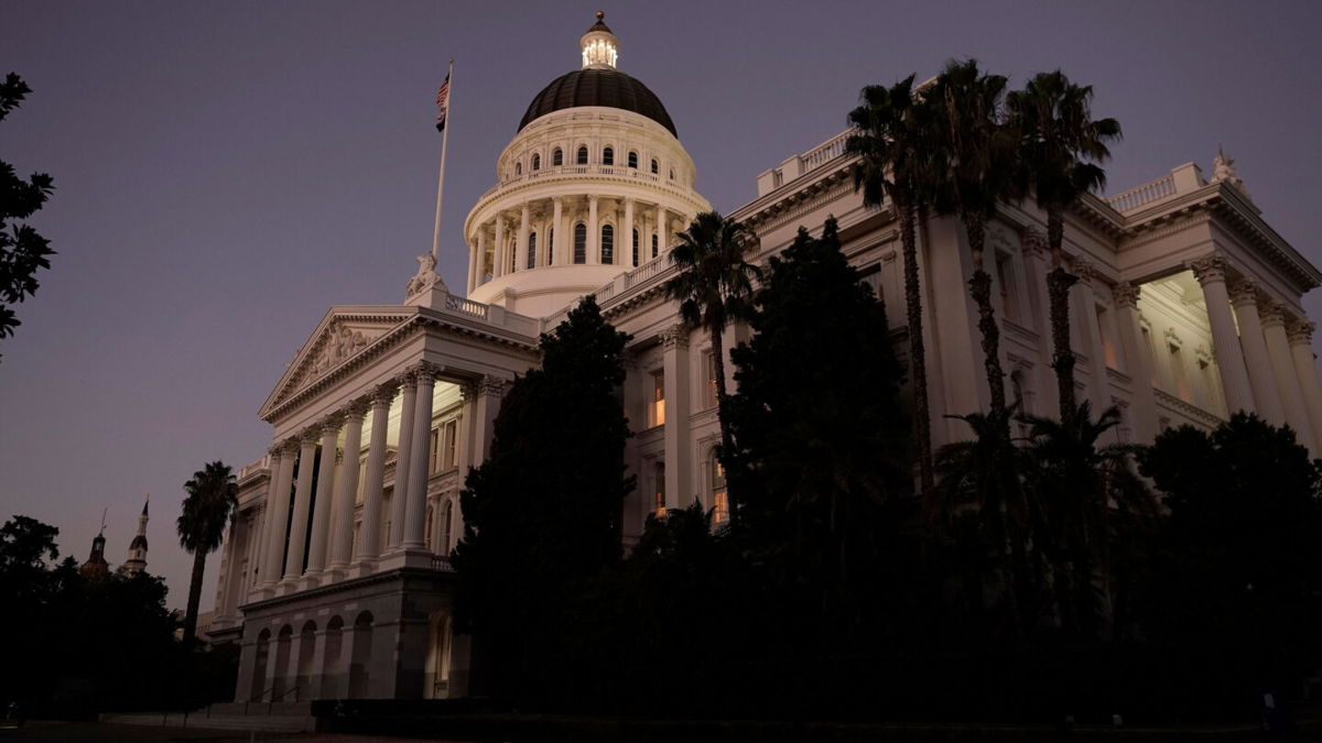 <i>Rich Pedroncelli/AP</i><br/>The lights of the California state Capitol glow into the night in Sacramento on August 31. California passed a 'historic' legislative package protecting or expanding abortion access.