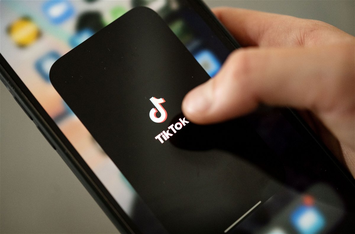 <i>Marijan Murat/picture alliance/Getty Images</i><br/>A teenager taps the TikTok logo on a smartphone. A research report this week says nearly 20% of videos presented by TikTok's search engine contain misinformation on topics ranging from Covid-19 to the January 6