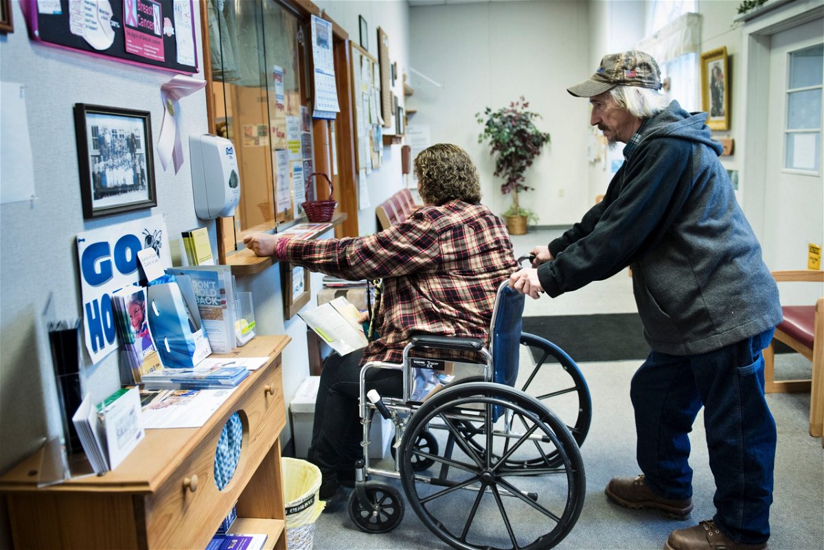 <i>BRENDAN SMIALOWSKI/AFP/Getty Images</i><br/>A patient checks in at the Community Health Center in March of 2017 in Burton