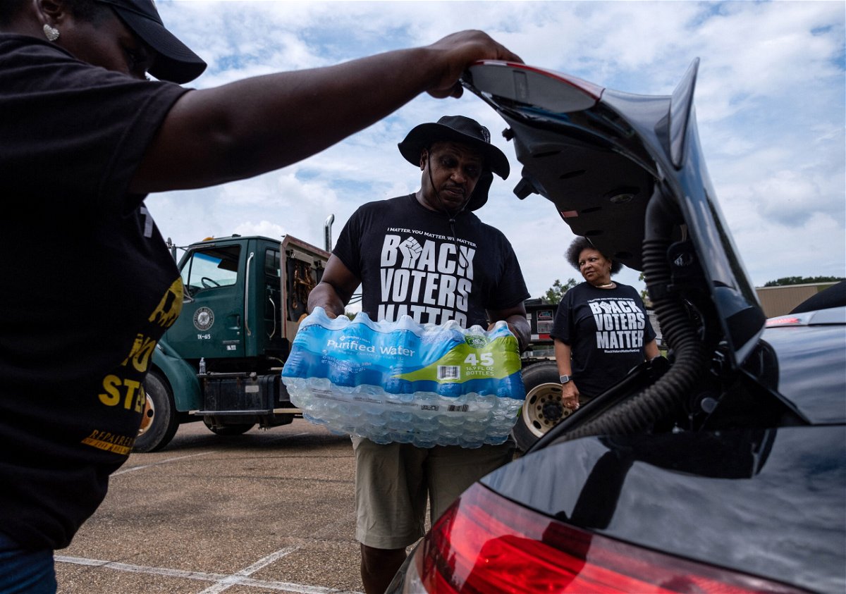 <i>Seth Herald/AFP/Getty Images</i><br/>Residents distributed cases of water in Jackson earlier this month.