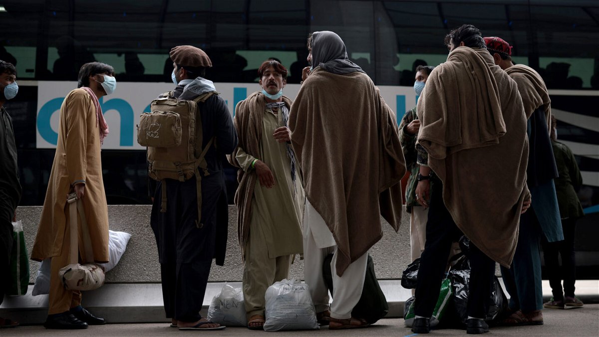 <i>Anna Moneymaker/Getty Images</i><br/>The Biden administration is pivoting to a long-term strategy to assist Afghans who worked with or on behalf of the US government. Refugees are pictured boarding a bus at Dulles International Airport on August 31.