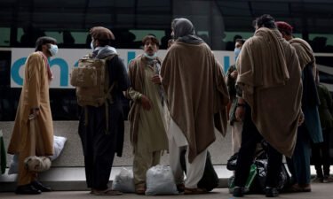 The Biden administration is pivoting to a long-term strategy to assist Afghans who worked with or on behalf of the US government. Refugees are pictured boarding a bus at Dulles International Airport on August 31.