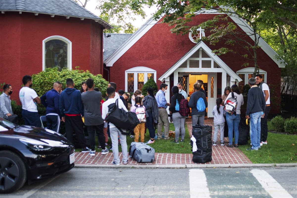 <i>Ray Ewing/Vineyard Gazette/AP</i><br/>The migrants gather outside the church on September 14.