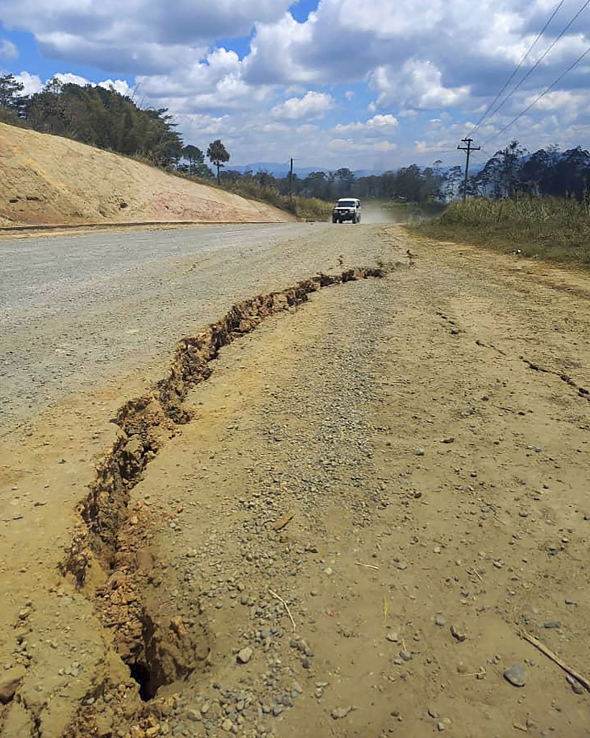 <i>Renagi Ravu/AP</i><br/>A large crack in a highway near the town of Kainantu