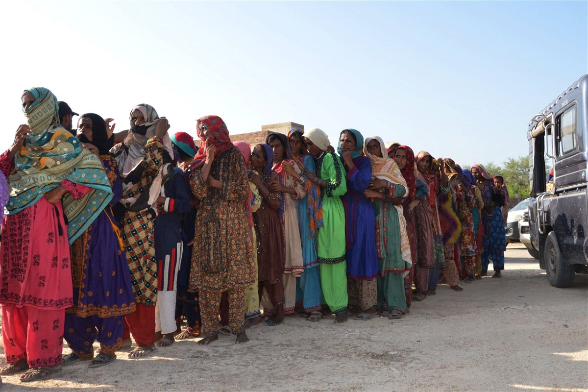 <i>Fida Hussain/AFP/Getty Images</i><br/>Flood victims line up up to receive food aid at Dera Allah Yar town of Jaffarabad district in Balochistan province on September 17.