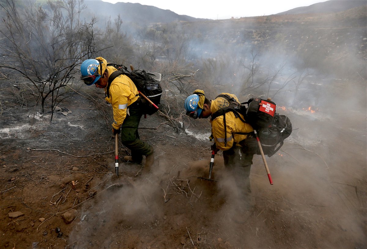 <i>Luis Sinco/Los Angeles Times/Getty Images</i><br/>Light rain and higher humidity gave firefighters a chance to get more containment around the Fairview Fire