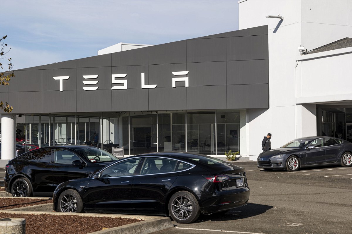 <i>David Paul Morris/Bloomberg/Getty Images</i><br/>A customer looks at a vehicle at a Tesla dealership in Vallejo
